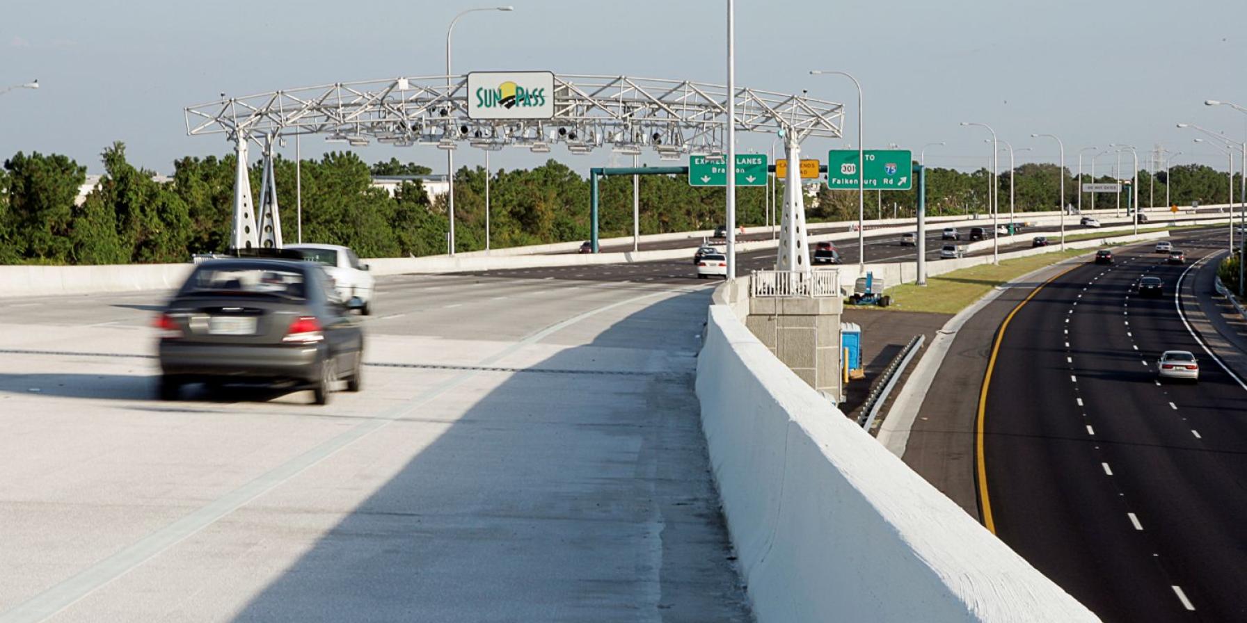 Car on road with view of a Sunpass sign ahead