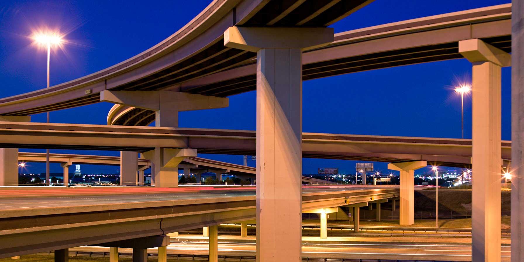 Night view of stacked highway overpasses.