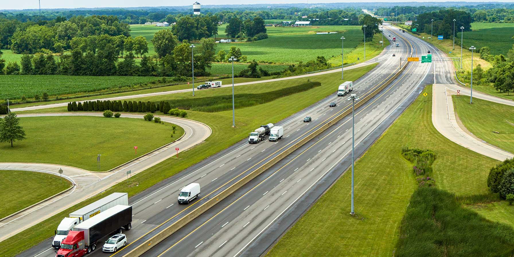 Aerial view of I-70 East with vehicles and surrounding farmland