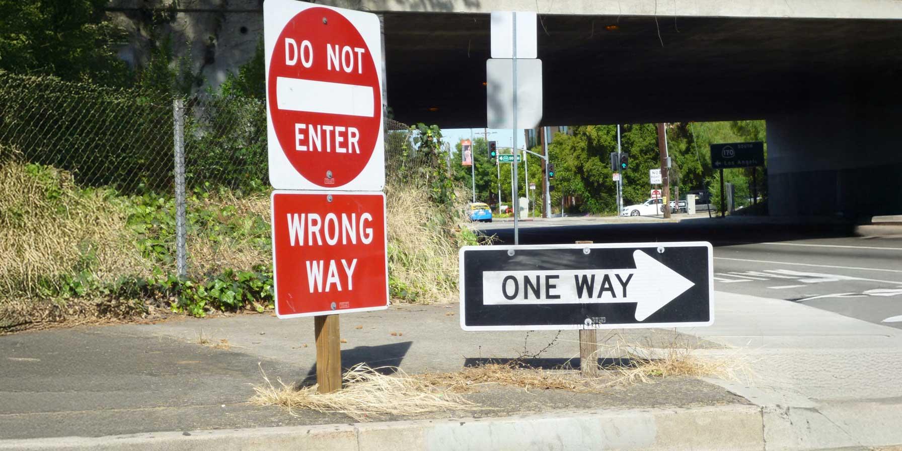 Do Not Enter and One Way signs at street corner