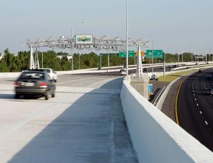 Car on road with view of a Sunpass sign ahead
