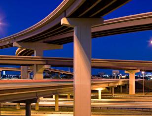 Night view of stacked highway overpasses.