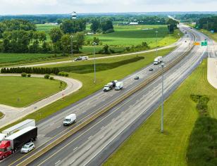 Aerial view of I-70 East with vehicles and surrounding farmland