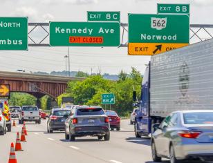 Highway scene with traffic, police vehicle, and lane closure