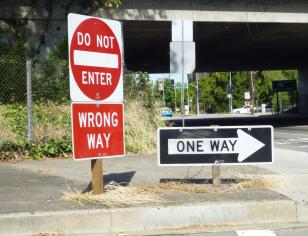 Do Not Enter and One Way signs at street corner
